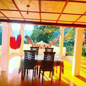 a dining room with a table and four chairs at New Farmers Paradise in Ella