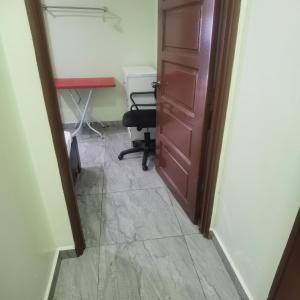 Cette chambre dispose d'une porte, d'un bureau et d'une chaise. dans l'établissement 1号房有厕所厨房冰箱洗衣机, à Kuala Lumpur
