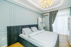 a bedroom with a large bed with a large window at Baku Sea View 3 bedroom in Baku