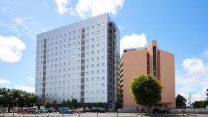 a large white building with cars parked in front of it at Toyoko Inn Narita Airport Honkan in Narita +43 photos