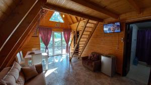 a living room of a wooden house with a staircase at Sionis Idilia in Sioni
