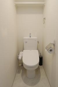 a bathroom with a white toilet in a stall at Residence Hotel Hakata 19 in Fukuoka