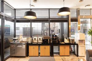 an office with a counter with appliances and windows at H-AVENUE Hotel Yeoksam in Seoul