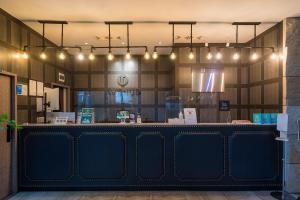 a restaurant with a blue counter with lights above it at H-AVENUE Hotel Yeoksam in Seoul