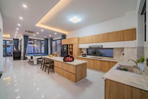 a kitchen with a pool table and a dining room at Blue Sea Villa Vũng Tàu 5 in Vung Tau