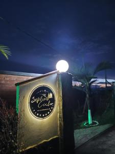 a light on top of a sign at night at Septimo Cielo Tiny Homes in Guatapé