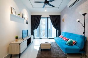 uma sala de estar com um sofá azul e uma grande janela em 新房源 KL Homestay , KLCC & MITEC 15Mins , (6-10Pax) em Kuala Lumpur