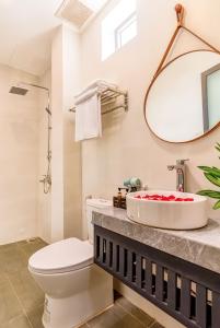 a bathroom with a toilet and a sink at Tomorrow Boutique Villa Hoi An in Hoi An