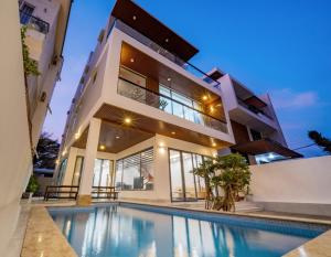 a house with a swimming pool in front of it at Blue Sea Villa Vũng Tàu 5 in Vung Tau