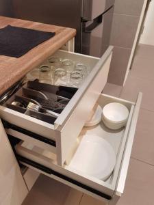 a drawer in a kitchen with plates and utensils at G Residence - 2R2B Barrington Night Market (1) in Brinchang