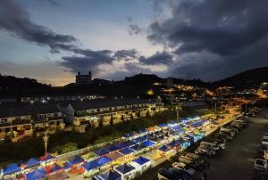 a city with a bunch of cars parked in a parking lot at G Residence - 2R2B Barrington Night Market (1) in Brinchang