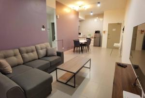 a living room with a couch and a table at G Residence - 2R2B Barrington Night Market (1) in Brinchang