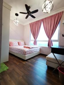 a bedroom with a bed and a ceiling fan at English Homestay Seaview Johor Bahru Permas 6 pax in Masai