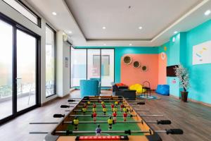 a room with a ping pong table in the middle at Sans Hotel Rajawali Surabaya by RedDoorz in Krembangan