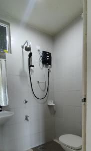 a shower in a bathroom with a toilet and a sink at KB Studio @D'Perdana Apartment in Kota Bharu