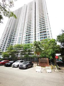 a large building with cars parked in front of it at English Homestay Seaview Johor Bahru Permas 6 pax in Masai