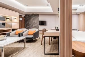 a living room with a couch and a table at TH Hotel in Pingtung City