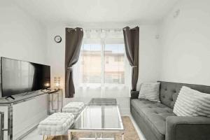 a living room with a couch and a coffee table at Entire NEW Cozy and Modern 2-storey HOUSE in Vancouver