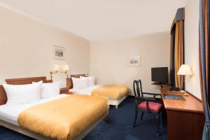 Postel nebo postele na pokoji v ubytování Radisson Blu Hotel Halle-Merseburg + 37 fotografií