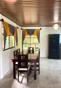 a dining room with a wooden table and chairs at Casa Montaña & Spa Pital de San Carlos Costa Rica in Pital
