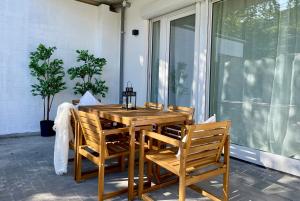 a wooden table and chairs on a porch at Condo Apartments Hamburg in Hamburg