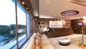 - un hall avec un canapé et une télévision dans un bâtiment dans l'établissement Aloka Stay Inn, à Vellore