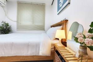 a bedroom with a bed and a table with a lamp at Hongdae Stn 2min 2R 1F #Core Stay 101 in Seoul
