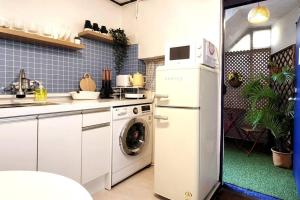 a kitchen with a white refrigerator and a washing machine at Hongdae Stn 2min 2R 1F #Core Stay 101 in Seoul