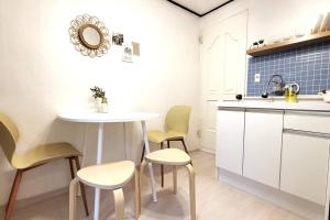 a kitchen with a table and chairs and a sink at Hongdae Stn 2min 2R 1F #Core Stay 101 in Seoul