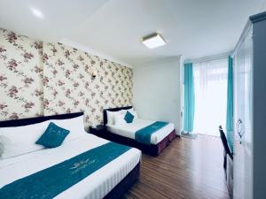 Postel nebo postele na pokoji v ubytování Dalat Eco Hotel