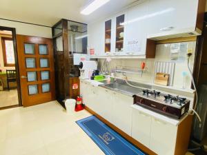 a kitchen with a sink and a stove at Aroha house for Foreign guests only in Seoul