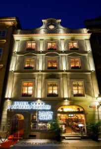 a building lit up at night with a music club at Hotel U Zlatého Stromu Prague by BHG in Prague