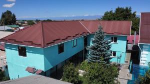an overhead view of a blue building with a red roof at Guesthouse Alakol in Karakol