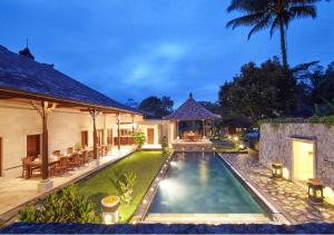 a backyard with a swimming pool and a house at Bagus Jati Health & Wellbeing Retreat in Tegalalang