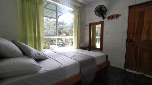 Postel nebo postele na pokoji v ubytování Hostal Vista Hermosa