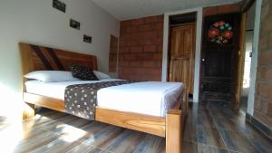 Postel nebo postele na pokoji v ubytování Hostal Vista Hermosa