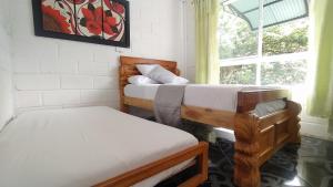 Postel nebo postele na pokoji v ubytování Hostal Vista Hermosa