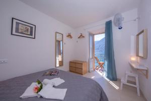 a bedroom with a bed and a window with a view at Colonno Fronte Lago in Colonno