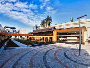a large building with a courtyard in front of it at Nepalirika Hotel Damak in Pānigata