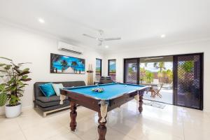 a living room with a pool table and a couch at 4BR Smithfield Serenity; Pool, BBQ & Pool Table in Smithfield
