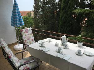 a white table and chairs on a balcony at Apartment Keka in Dramalj