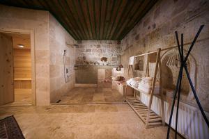 a bathroom with a walk in shower and a walk in shower at Serene Premium Stone House in Nevsehir