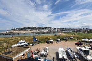 a group of boats parked on the sand near the beach at Le cocooning-studio Deauville Marina avec terrasse vue mer et plage in Deauville