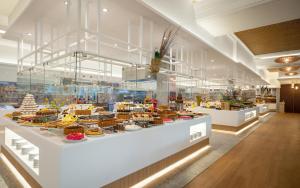 a bakery with a display case filled with lots of food at Iberostar Mehari Djerba in Taguermess