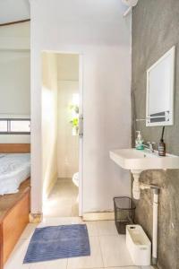 a bathroom with a sink and a toilet and a mirror at Teras Sabin in Ngabean