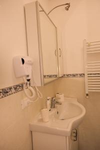 a bathroom with a sink and a mirror at Ludo’s Home in Florence