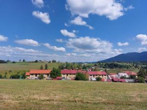 a small town in a field with a green field at Apartment Šula in Pljevlja