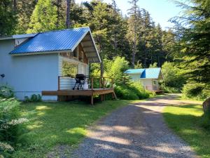 a tiny house with a solar roof on a gravel road at Beach Roadhouse in Haines