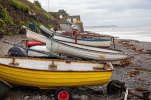 a group of boats sitting on the beach at Inn on the Shore in Downderry