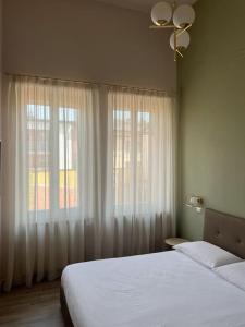 1 dormitorio con 2 camas y ventana en La casa di Alice, en Parma